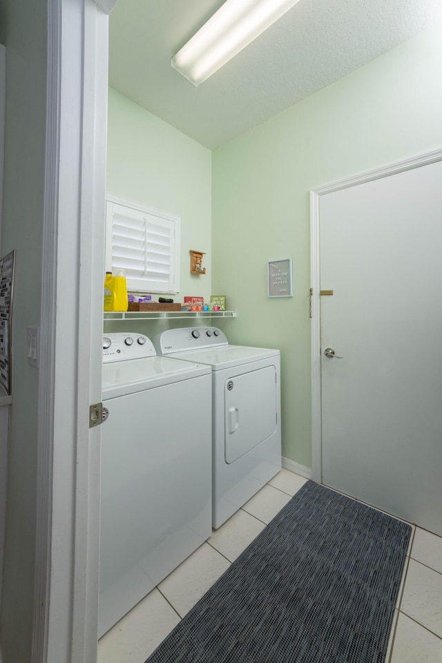 520 NW Galatone Ct, Port Saint Lucie, FL 34986 - washroom with light tile patterned floors, laundry area, and washer and dryer