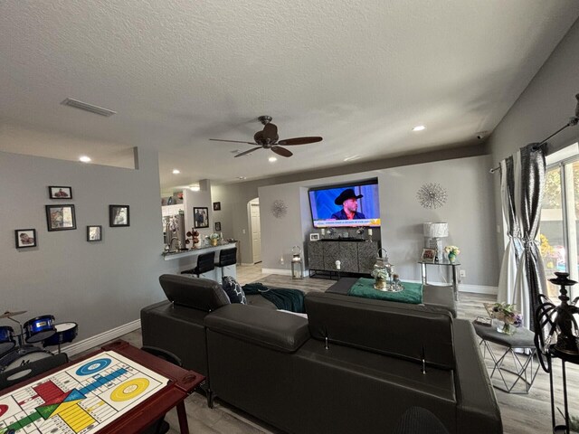 7746 99th Ct, Vero Beach, FL 32967 - living room featuring visible vents, a ceiling fan, baseboards, and a textured ceiling