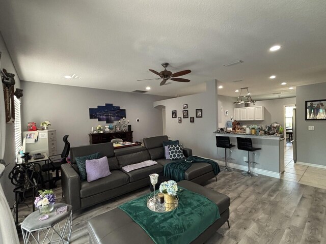 7746 99th Ct, Vero Beach, FL 32967 - living area featuring visible vents, ceiling fan, recessed lighting, arched walkways, and light wood finished floors