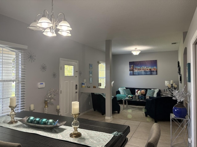 7746 99th Ct, Vero Beach, FL 32967 - dining space with light tile patterned floors, visible vents, and a notable chandelier