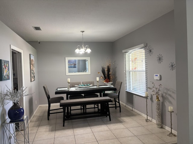 7746 99th Ct, Vero Beach, FL 32967 - dining space featuring visible vents, baseboards, light tile patterned floors, and an inviting chandelier