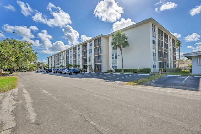 view of property featuring uncovered parking