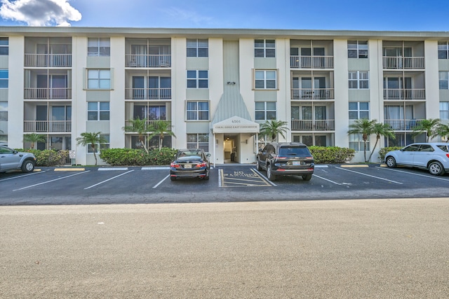 view of building exterior featuring uncovered parking