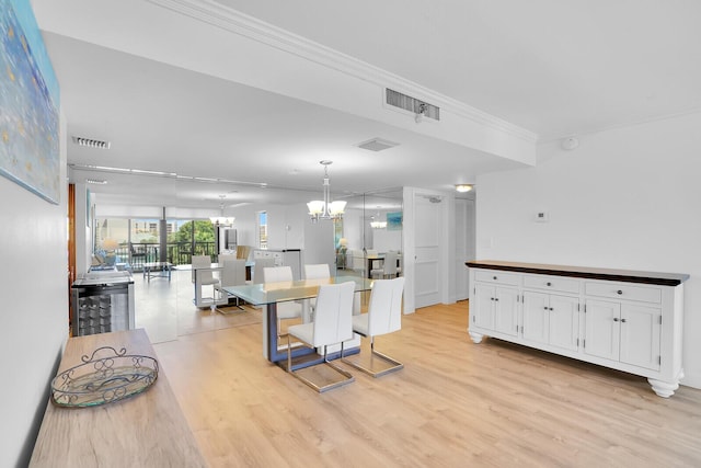 kitchen with visible vents, light wood finished floors, a notable chandelier, and white cabinets