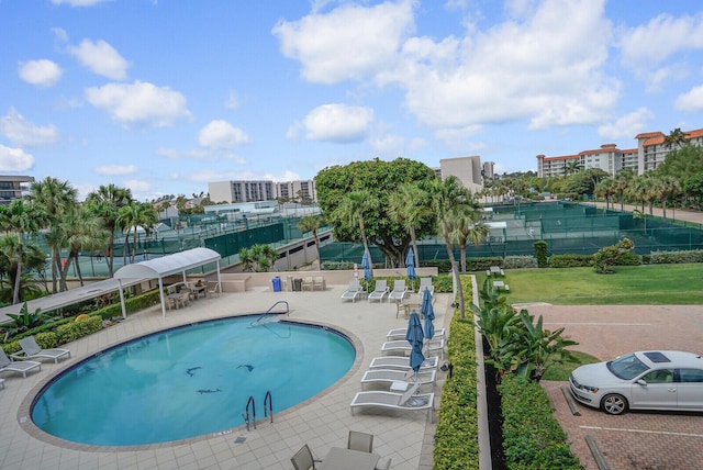 pool with fence and a patio area