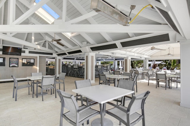 view of patio featuring a gazebo, outdoor dining area, and ceiling fan
