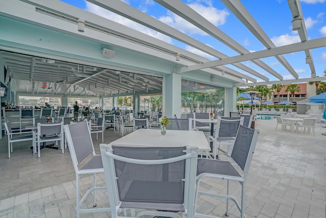 view of patio / terrace featuring a pergola and outdoor dining space