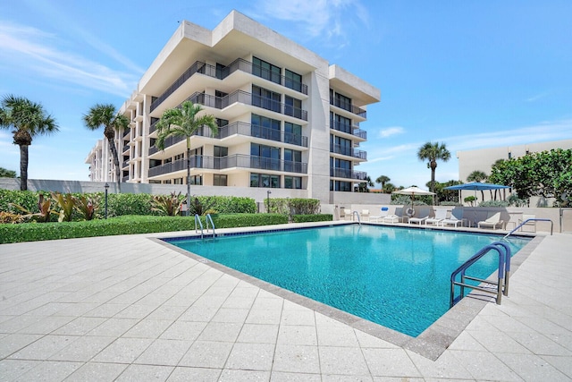 community pool featuring fence and a patio area