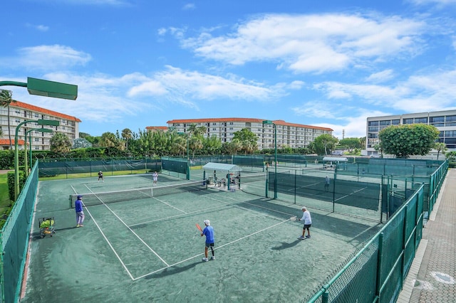 view of tennis court featuring fence