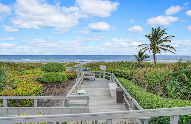 view of home's community featuring a water view and a view of the beach