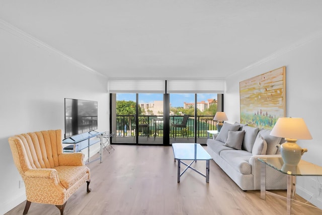 living area featuring crown molding, wood finished floors, and a wealth of natural light