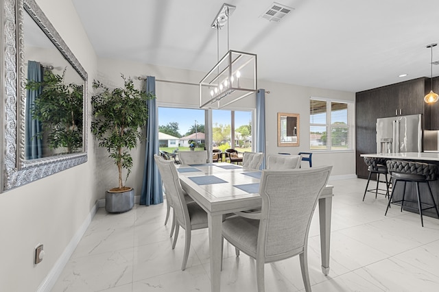 10867 Jefferson Way, Boynton Beach, FL 33437 - dining area featuring a chandelier, baseboards, visible vents, and marble finish floor