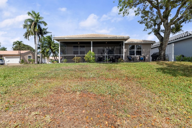 10867 Jefferson Way, Boynton Beach, FL 33437 - rear view of house featuring a lawn, a sunroom, and a tile roof