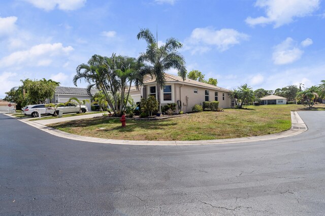 10867 Jefferson Way, Boynton Beach, FL 33437 - view of front facade with a front lawn and stucco siding