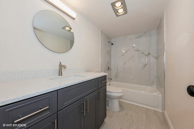 full bathroom with toilet, wood finished floors, vanity, and shower / washtub combination