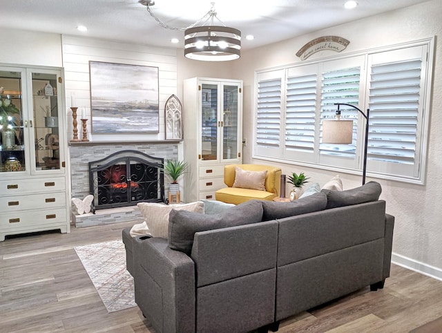 380 Laurie Rd, West Palm Beach, FL 33405 - living area with wood finished floors, recessed lighting, a lit fireplace, and baseboards