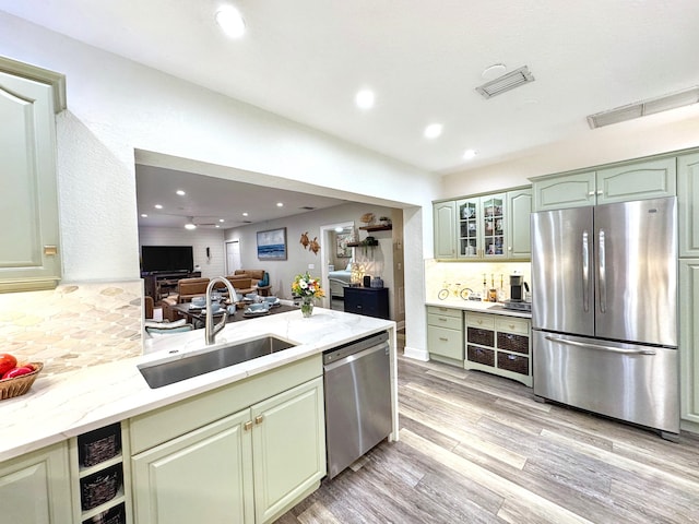 380 Laurie Rd, West Palm Beach, FL 33405 - kitchen with appliances with stainless steel finishes, green cabinets, a sink, backsplash, and recessed lighting