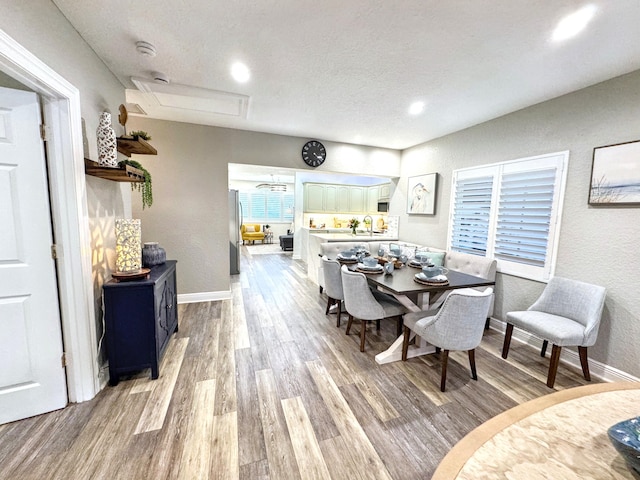 380 Laurie Rd, West Palm Beach, FL 33405 - dining space featuring light wood-style floors, baseboards, recessed lighting, and a textured wall