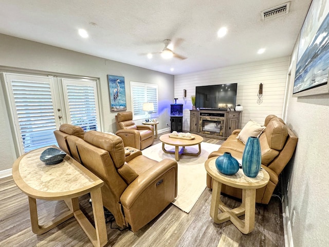 380 Laurie Rd, West Palm Beach, FL 33405 - living room with light wood-style flooring, ceiling fan, a glass covered fireplace, recessed lighting, and a textured ceiling