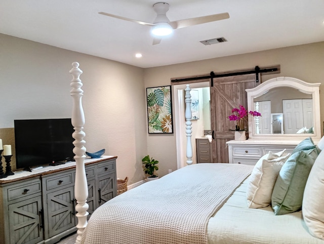 380 Laurie Rd, West Palm Beach, FL 33405 - bedroom with a barn door and a ceiling fan