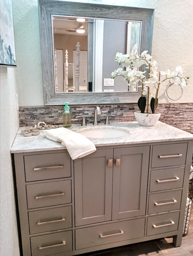 380 Laurie Rd, West Palm Beach, FL 33405 - bathroom featuring a textured wall, vanity, and wood finished floors