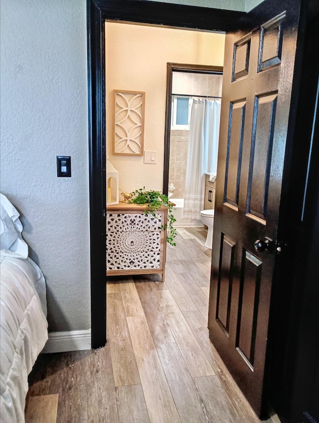 380 Laurie Rd, West Palm Beach, FL 33405 - foyer entrance featuring a textured wall, wood finished floors, and baseboards