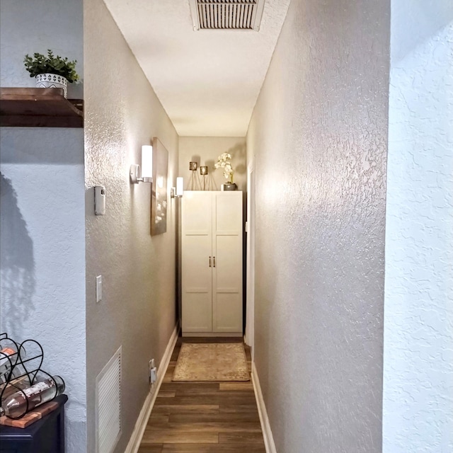 380 Laurie Rd, West Palm Beach, FL 33405 - corridor with wood finished floors, a textured wall, and baseboards