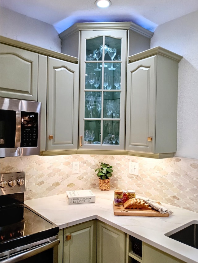 kitchen with stainless steel appliances and backsplash