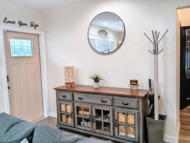 380 Laurie Rd, West Palm Beach, FL 33405 - foyer entrance with wood finished floors, baseboards, and a textured wall