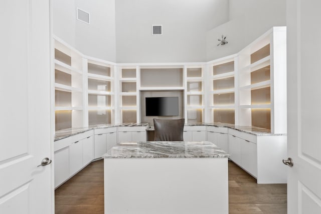 6950 NW 25th Way, Boca Raton, FL 33496 - kitchen featuring wood finished floors, white cabinets, light stone countertops, and a kitchen island