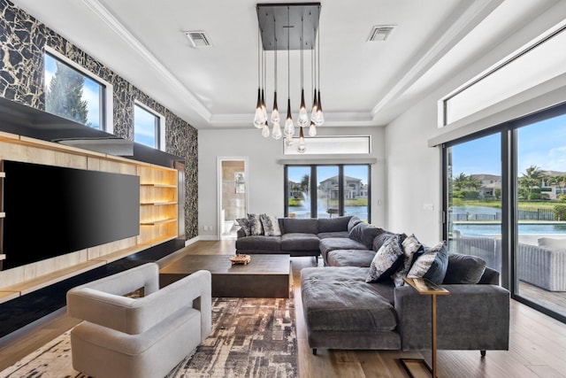 6950 NW 25th Way, Boca Raton, FL 33496 - living room with wood finished floors, a tray ceiling, a chandelier, and a water view
