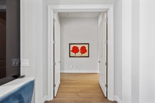 6950 NW 25th Way, Boca Raton, FL 33496 - hallway featuring light wood finished floors and baseboards