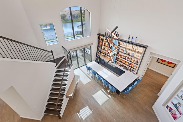 6950 NW 25th Way, Boca Raton, FL 33496 - stairs with a high ceiling, wood finished floors, and baseboards