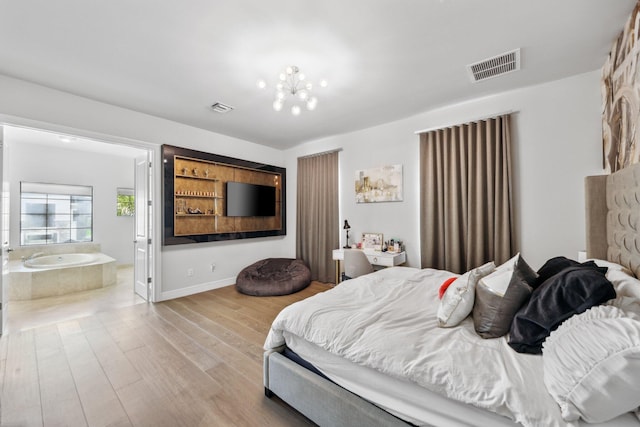 6950 NW 25th Way, Boca Raton, FL 33496 - bedroom featuring wood finished floors, ensuite bathroom, and baseboards