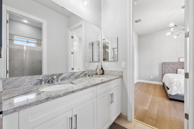 6950 NW 25th Way, Boca Raton, FL 33496 - bathroom with wood finished floors, double vanity, baseboards, and ensuite bathroom