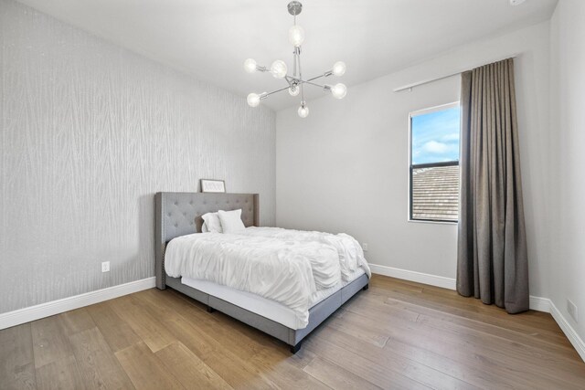 6950 NW 25th Way, Boca Raton, FL 33496 - bedroom featuring wood finished floors, baseboards, and a chandelier