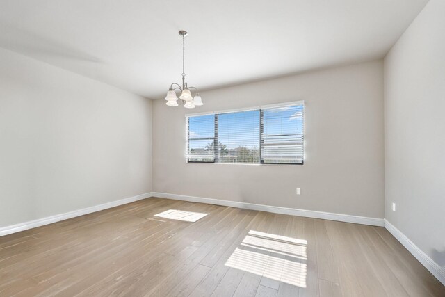 6950 NW 25th Way, Boca Raton, FL 33496 - unfurnished room featuring a chandelier, baseboards, and wood finished floors
