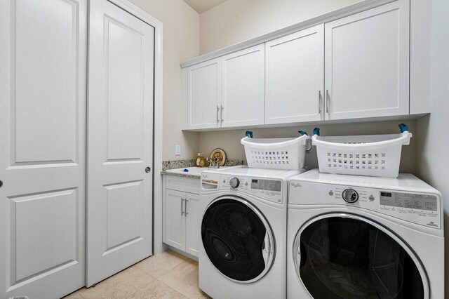 6950 NW 25th Way, Boca Raton, FL 33496 - clothes washing area with cabinet space, separate washer and dryer, and light tile patterned floors