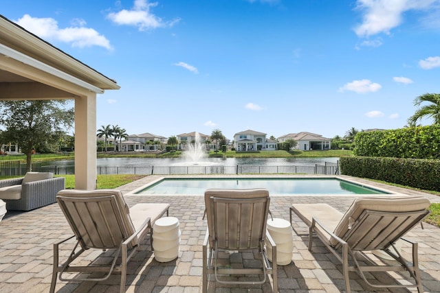 6950 NW 25th Way, Boca Raton, FL 33496 - view of swimming pool featuring a water view, a patio, fence, and a residential view