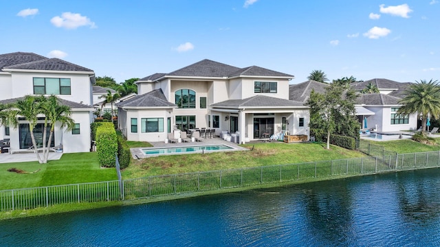 6950 NW 25th Way, Boca Raton, FL 33496 - back of house featuring a water view, outdoor lounge area, a patio, and stucco siding