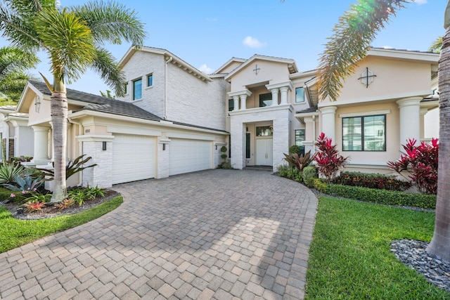 6950 NW 25th Way, Boca Raton, FL 33496 - view of front of property with decorative driveway, stucco siding, a front yard, and an attached garage