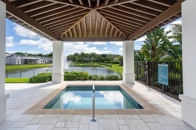 6950 NW 25th Way, Boca Raton, FL 33496 - view of pool featuring a water view, fence, and a patio area