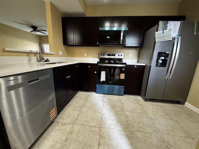 1103 Golden Lakes Blvd Unit 1011, West Palm Beach, FL 33411 - kitchen with stainless steel appliances, a sink, ceiling fan, light countertops, and light tile patterned floors