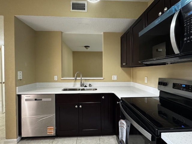 1103 Golden Lakes Blvd Unit 1011, West Palm Beach, FL 33411 - kitchen featuring stainless steel appliances, a sink, light countertops, and dark cabinets