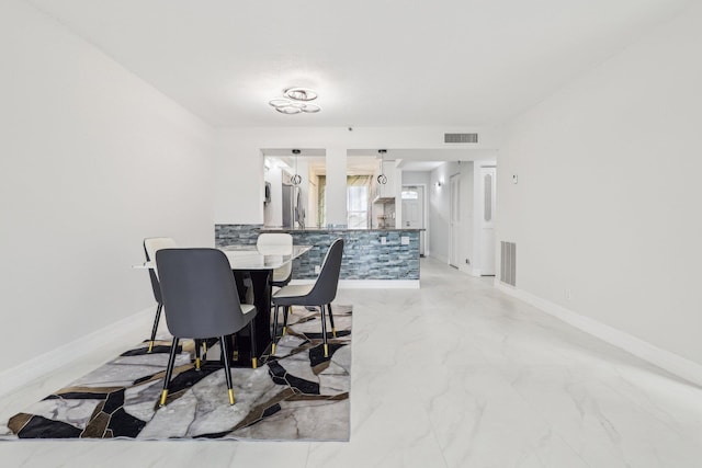 dining area with visible vents, marble finish floor, and baseboards