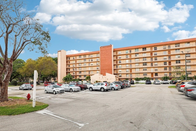 view of property featuring uncovered parking