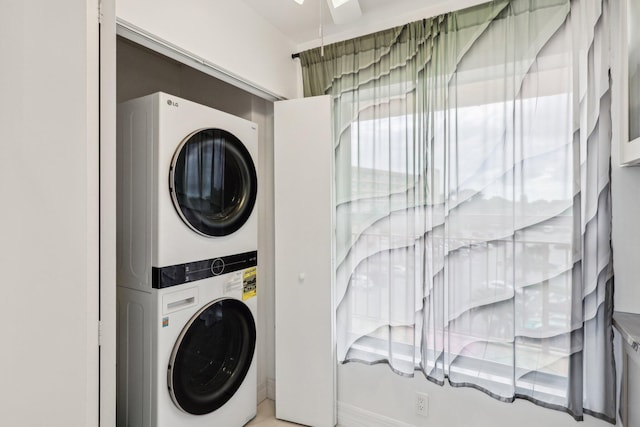 washroom with laundry area and stacked washer / dryer