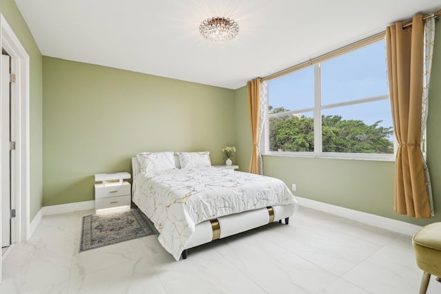 bedroom with baseboards and marble finish floor