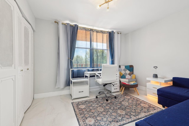 home office featuring baseboards and marble finish floor