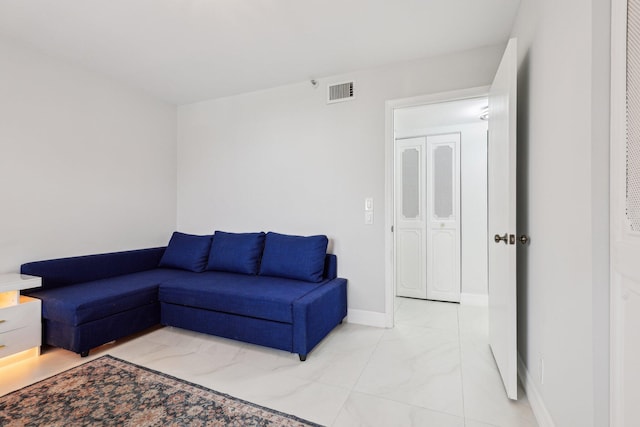 living area with visible vents and baseboards